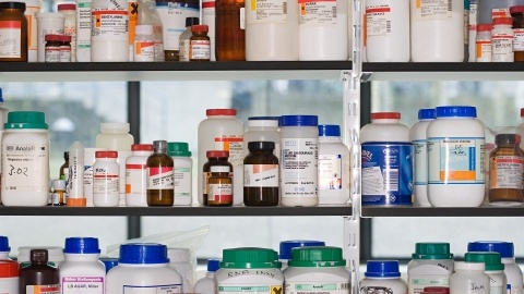bottles of chemicals on a laboratory shelf