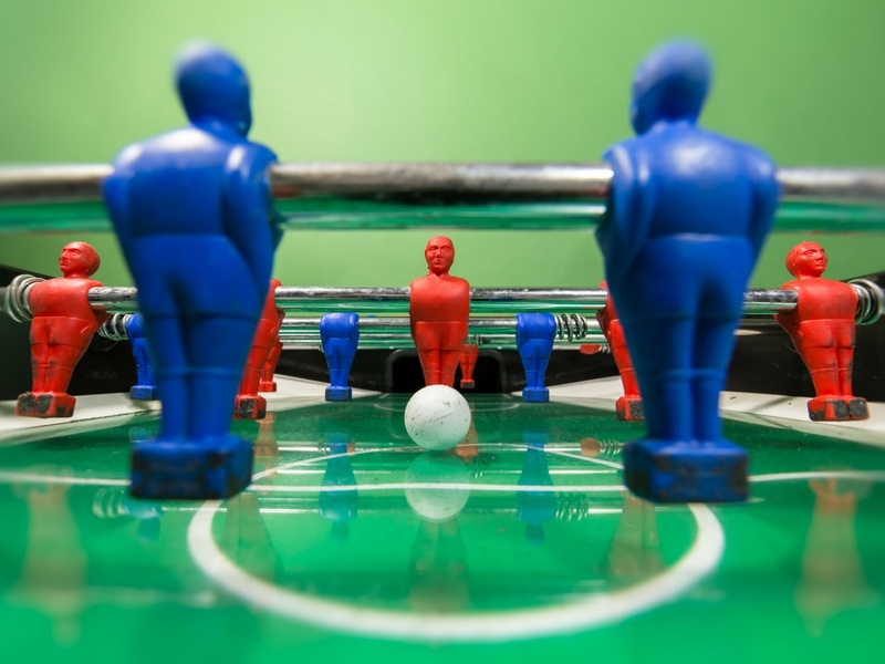 Close up view of Foosball table with ball positioned to be hit